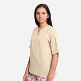 Left View of a Model wearing Beige 100% Cotton High Low Tunic Top