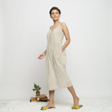 Left View of a Model wearing Beige Dabu Printed Button-Down Jumpsuit