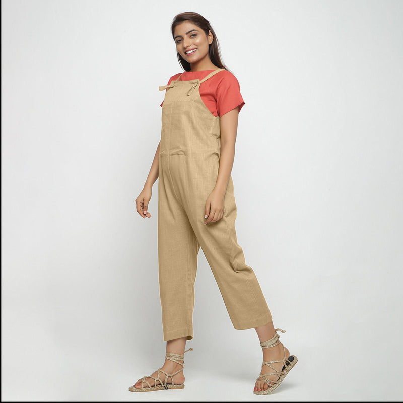 Left View of a Model wearing Beige Strap Sleeve Solid Dungaree