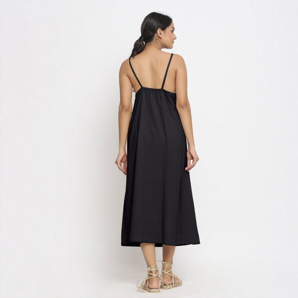 Back View of a Model wearing Black Cotton Flax Strap Sleeve A-Line Dress
