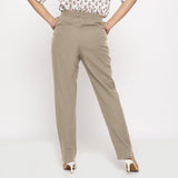 Back View of a Model wearing Cotton Flax Mid-Rise Beige Tapered Pant