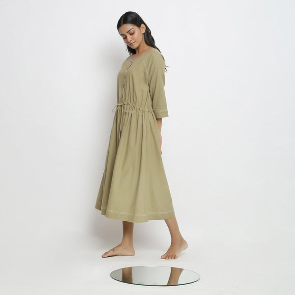 Left View of a Model wearing Green Vegetable Dyed Handspun Cotton Round Neck Button-Down Midi Dress