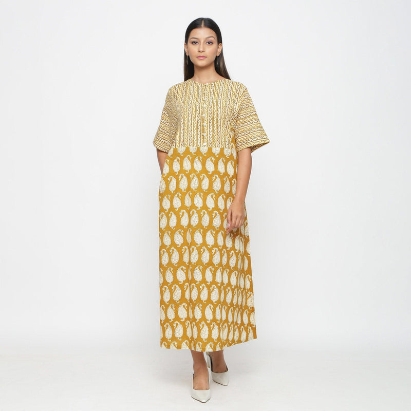 Front View of a Model wearing Mustard Block Printed Cotton Ankle Length Snug Dress