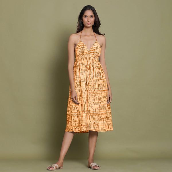 Front View of a Model wearing Rust Shibori Halter Neck Gathered Dress