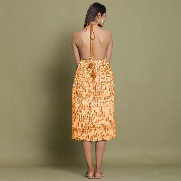 Back View of a Model wearing Rust Shibori Halter Neck Gathered Dress
