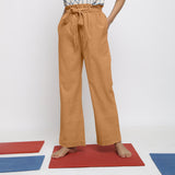 Front View of a Model wearing Rust Vegetable Dyed Wide Legged Paperbag Pant