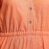 Front Detail of a Model wearing Salmon Pink Button-Down Godet Jumpsuit