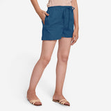 Right View of a Model wearing Teal Mid-Rise Cotton Straight Shorts