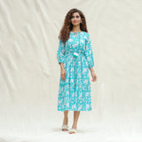 Front View of a Model wearing Turquoise Floral Block Printed Cotton Tier Midi Dress