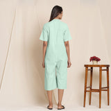 Back View of a Model wearing Cotton Aqua Box Pleated Jumpsuit