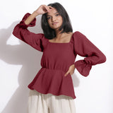 Front View of a Model wearing Cotton Waffle Barn Red Peplum Top