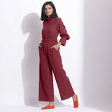 Left View of a Model wearing Barn Red Cotton Waffle Turtle Neck Overalls