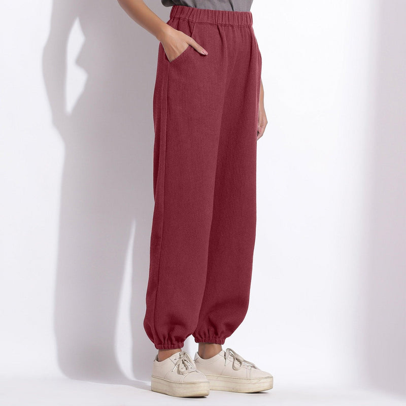 Right View of a Model wearing Comfy Barn Red Cotton Waffle Jogger Pants