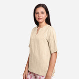 Left View of a Model wearing Beige 100% Cotton High Low Tunic Top