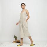 Left View of a Model wearing Beige Dabu Printed Button-Down Jumpsuit