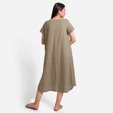 Back View of a Model wearing Beige Cotton Welt Pocket Shift Dress