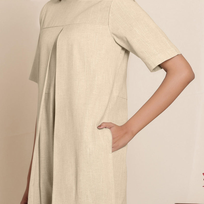 Front Detail of a Model wearing Cotton Beige Box Pleated Jumpsuit