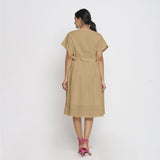 Back View of a Model wearing Beige Deep Neck Bohemian Frilled Dress