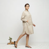 Right View of a Model wearing Beige Dabu Hand-Lep Cotton Knee Length Shirt Dress