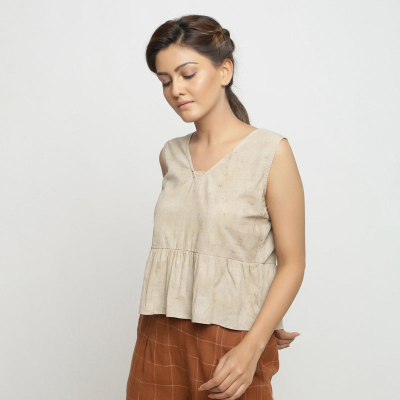 Left View of a Model wearing Beige Dabu Printed Sleeveless Gathered Top