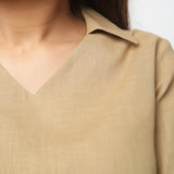 Front Detail of a Model wearing Beige Bracelet Sleeve Straight Top