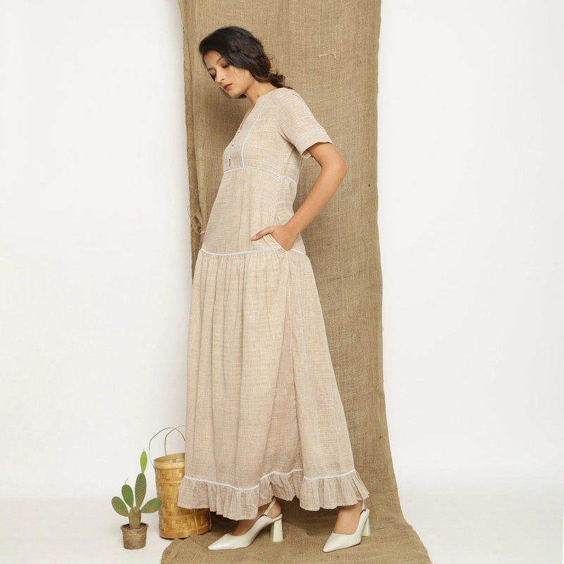 Left View of a Model wearing Handspun Cotton Lace Yoked Dress