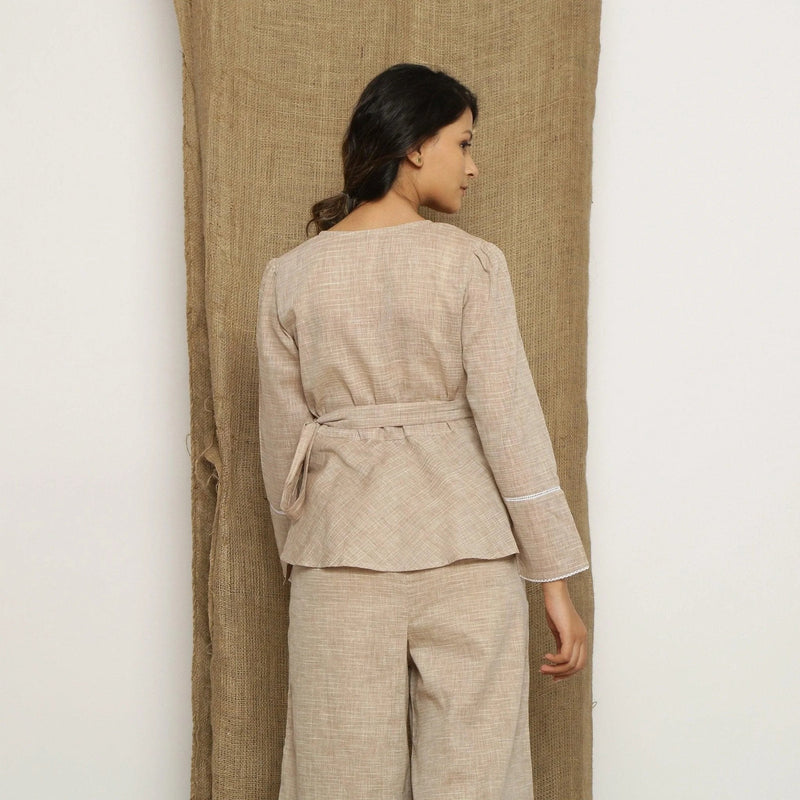 Back View of a Model wearing Beige Handspun Full Sleeve V-Neck Wrap Top