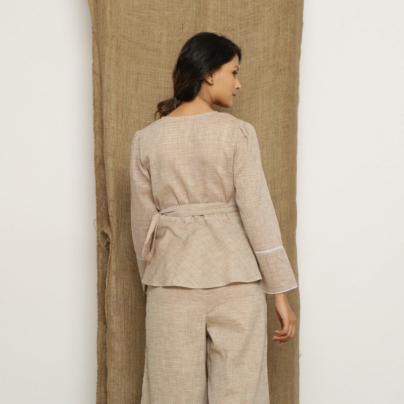 Back View of a Model wearing Beige Handspun Full Sleeve V-Neck Wrap Top