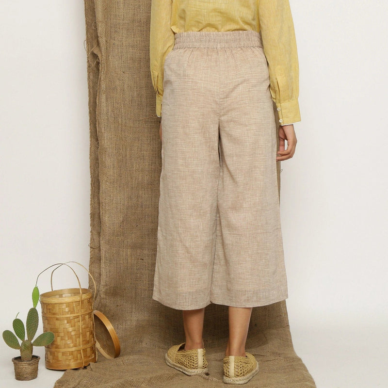 Back View of a Model wearing Beige Handspun Cotton Wide Legged Culotte