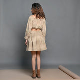 Back View of a Model wearing Beige Handwoven Cotton Frilled Crop Top