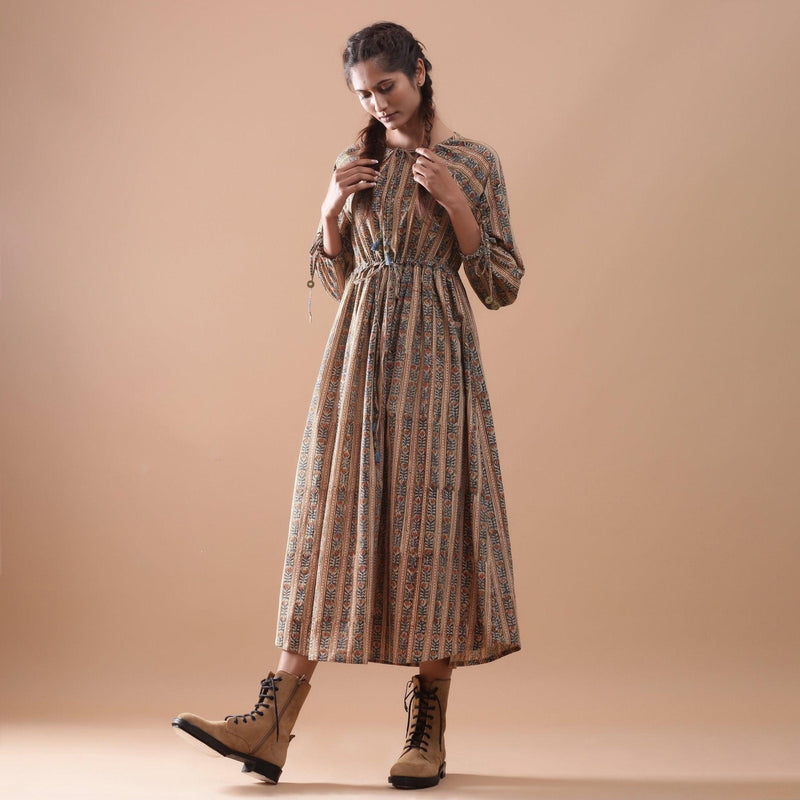 Left View of a Model wearing Beige Kalamkari Peasant Midi Dress