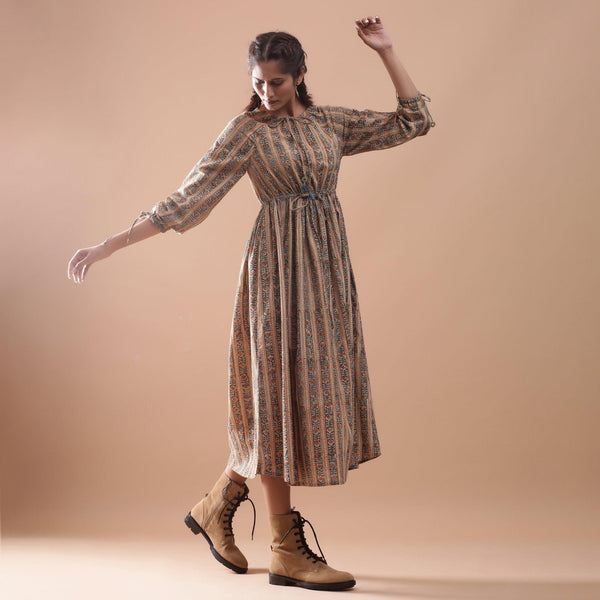 Right View of a Model wearing Beige Kalamkari Peasant Midi Dress