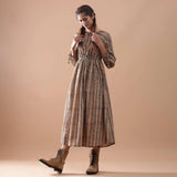 Left View of a Model wearing Beige Kalamkari Block Print Cotton Midi Dress