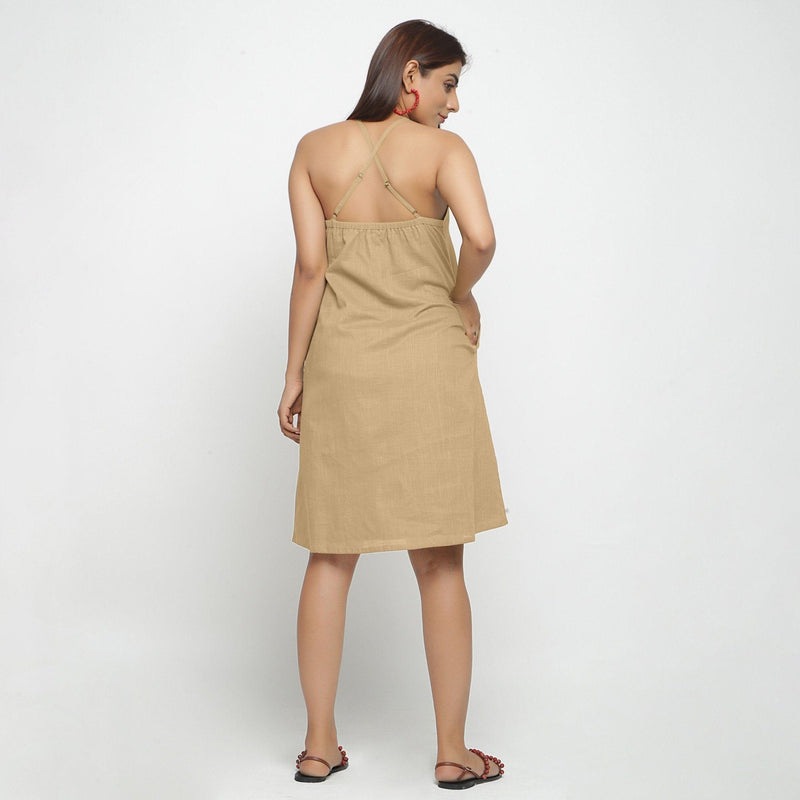 Back View of a Model wearing Beige Criss-Cross Cotton A-Line Dress