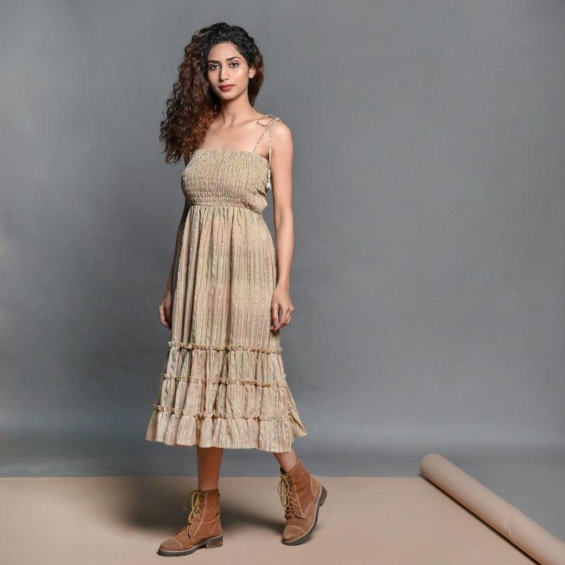 Left View of a Model wearing Beige Striped Handwoven Cotton Boho Tier Dress