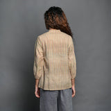 Back View of a Model wearing Beige Striped Handwoven Cotton Pleated Shirt