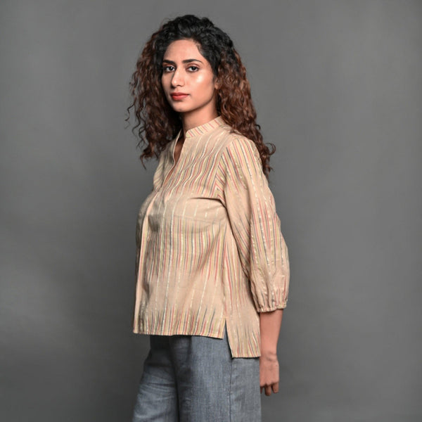 Left View of a Model wearing Beige Striped Handwoven Cotton Pleated Shirt