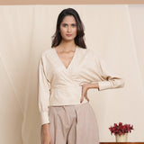 Front View of a Model wearing Beige Striped Surplice Blouson Top