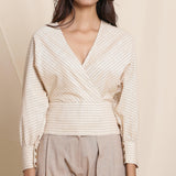 Front Detail of a Model wearing Beige Striped Surplice Blouson Top