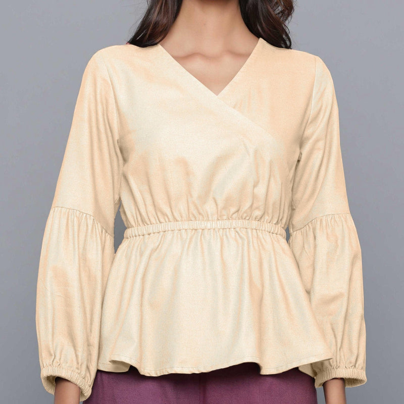 Front Detail of a Model wearing Beige V-Neck Flannel Peplum Top