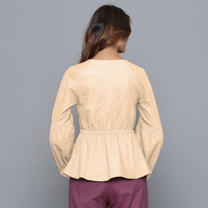 Back View of a Model wearing Beige V-Neck Flannel Peplum Top