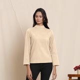 Front View of a Model wearing Warm Beige Turtle Neck Straight Top