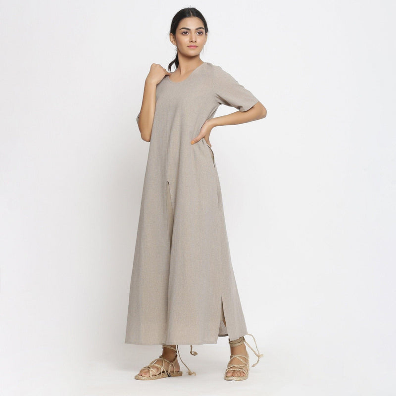 Left View of a Model wearing Beige Cotton Solid A-Line Slit Dress