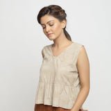 Left View of a Model wearing Beige Dabu Printed Sleeveless Gathered Top