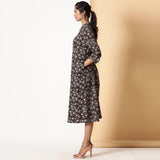 Left View of a Model wearing Black Bagru Block Printed Button-Down Dress