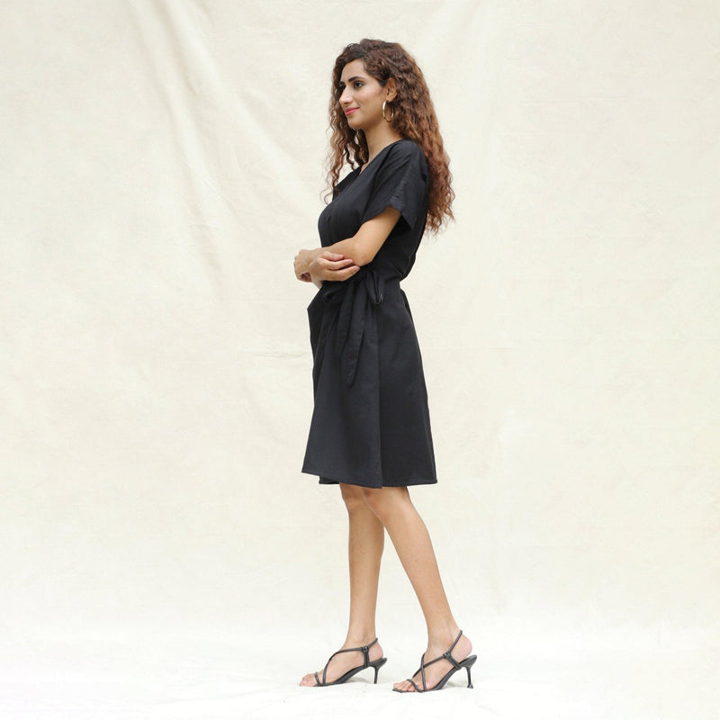 Left View of a Model wearing Black Cotton Flax A-Line Knee Length Wrap Dress