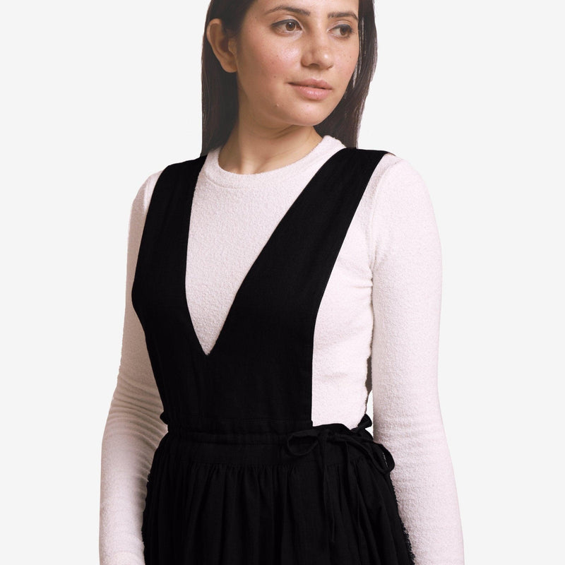 Front Detail of a Model wearing Black Deep Neck Pinafore Midi Wrap Dress