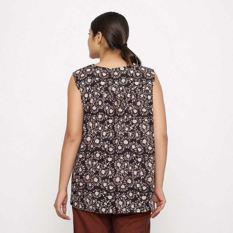 Back View of a Model wearing Black Floral Sleeveless Top