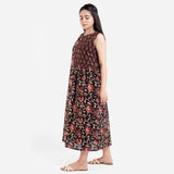 Left View of a Model wearing Black Floral Block Print Cotton Yoke Maxi Dress