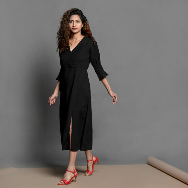 Left View of a Model wearing Black Handspun Cotton Pleated Midi Slit Dress